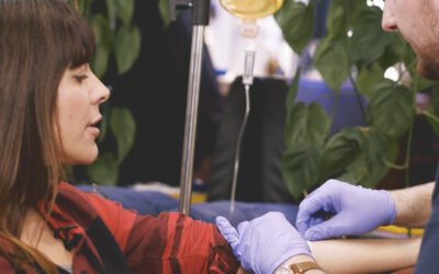 someone administering an IV Drip to a client