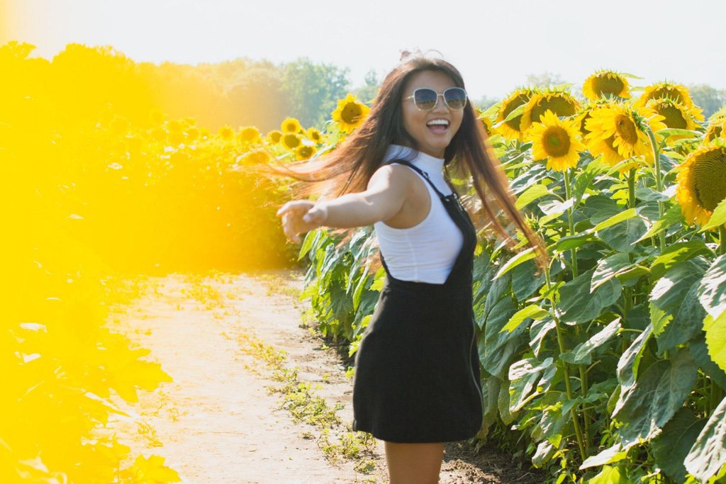 Lady in sunflower field
