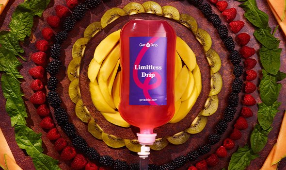 Limitless IV Drip bottle surrounded by fruit