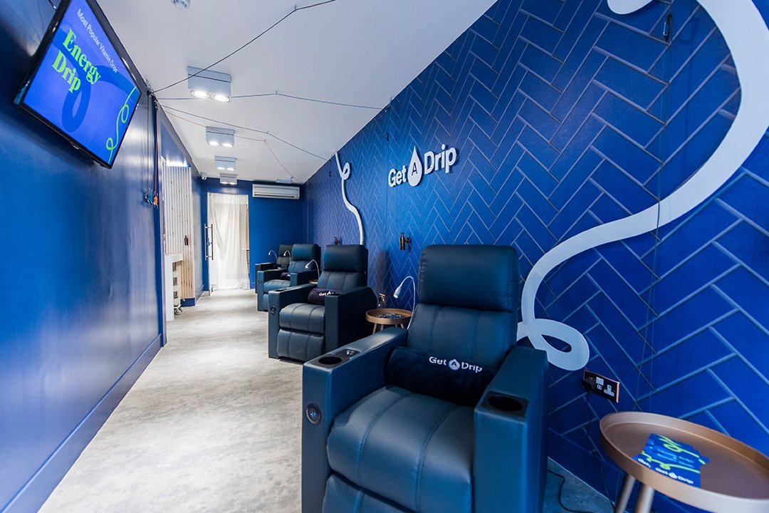 Iv Drip room with blue reclining chairs and blue panel walls