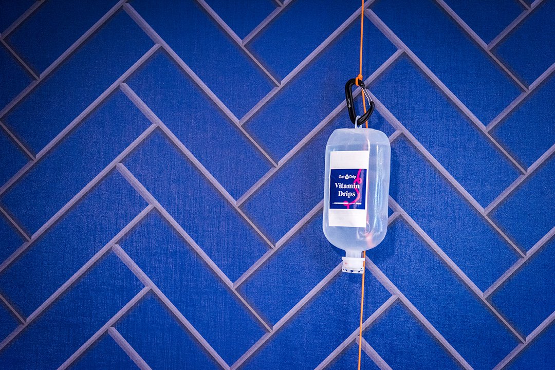 IV Drip bottle against blue panel wall